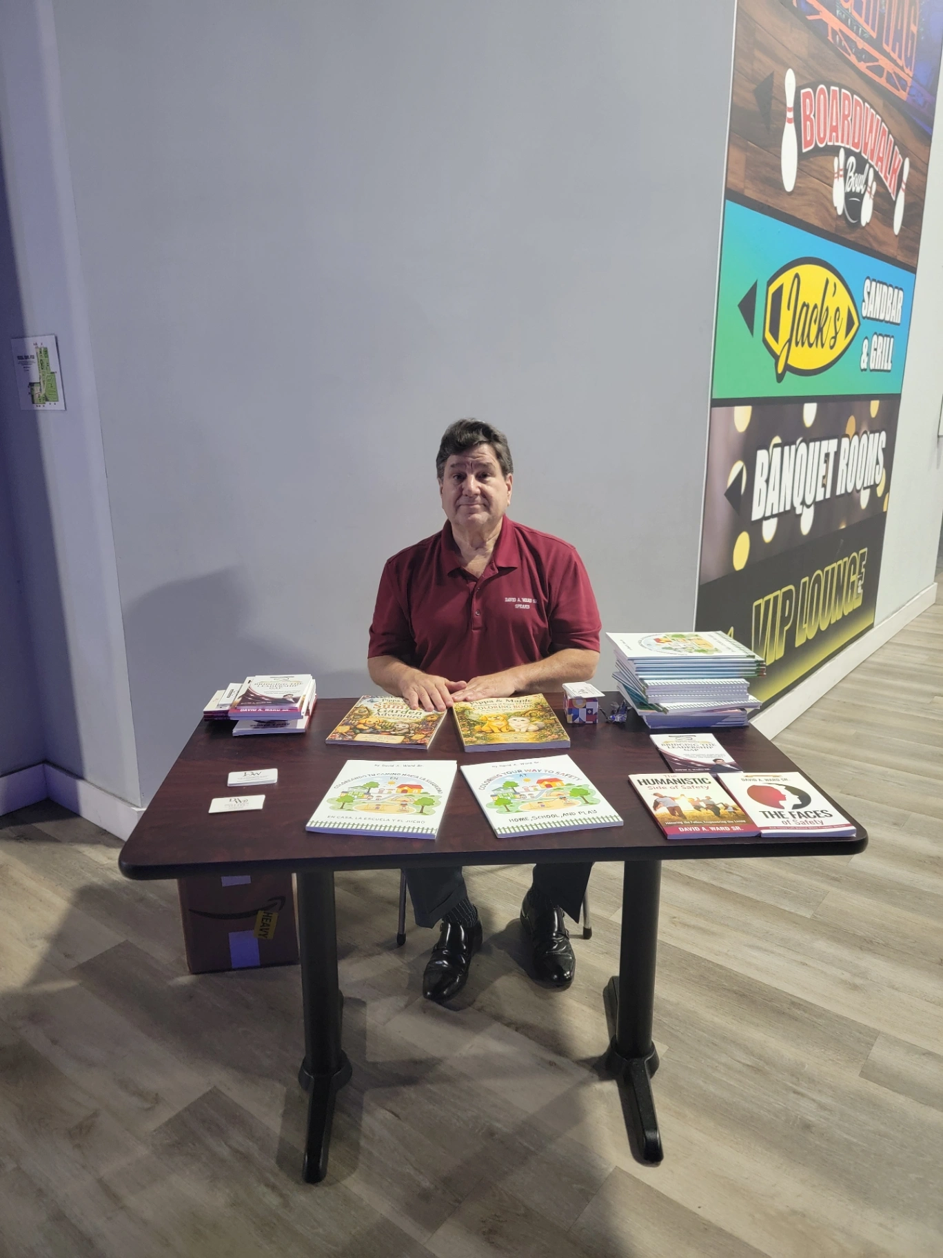David A. Ward Sr. at a community event table with Coloring Your Way to Safety and his other books
